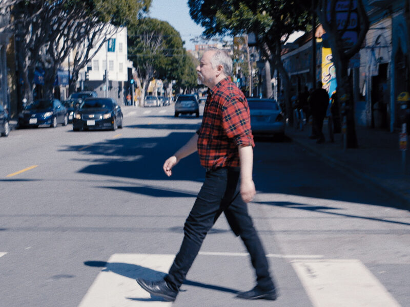 A man, Max Wolf Valerio, crosses a street in San Francisco in a still from the documentary "Genderation."